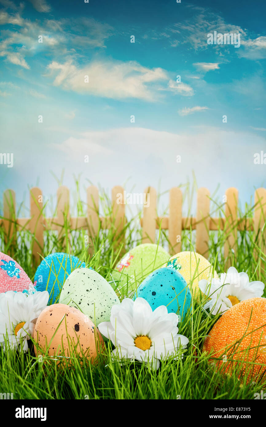 Decorated easter eggs in the grass on blue sky background Stock Photo ...