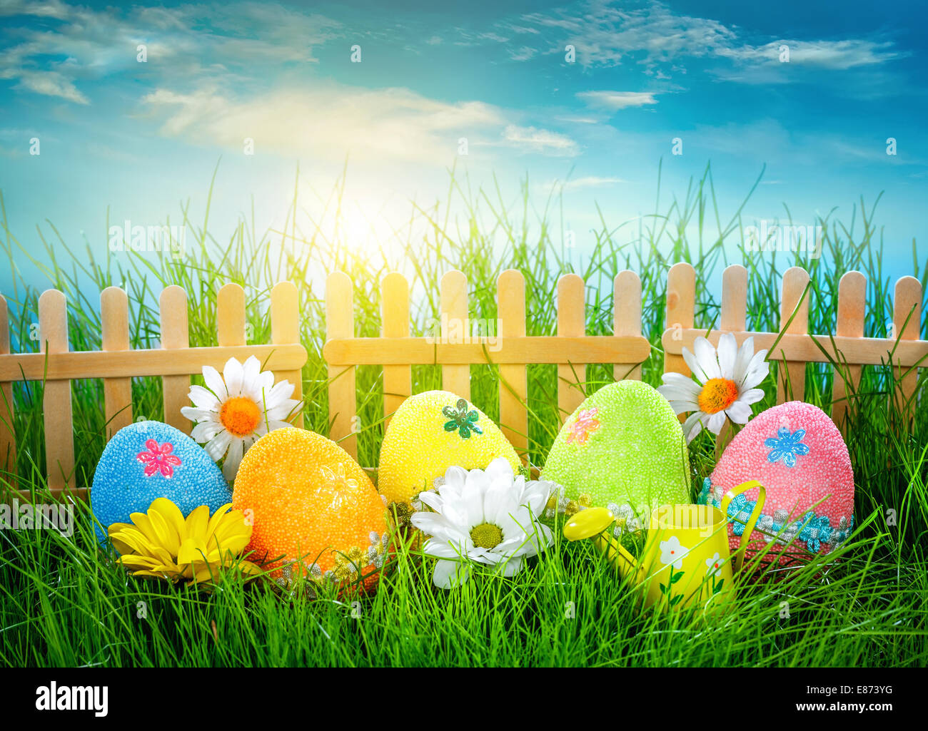 Decorated easter eggs in the grass on blue sky background Stock Photo ...