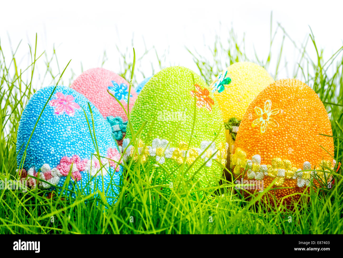 Decorated easter eggs in the grass on white background Stock Photo - Alamy
