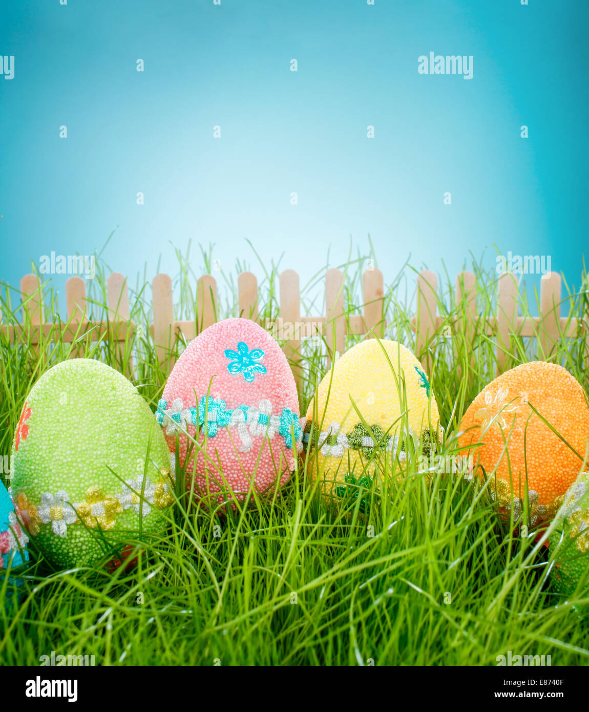 Decorated easter eggs in the grass on blue sky background Stock Photo ...