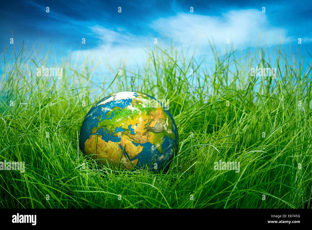 Globe lies on green grass. Concept - Earth Day Stock Photo - Alamy