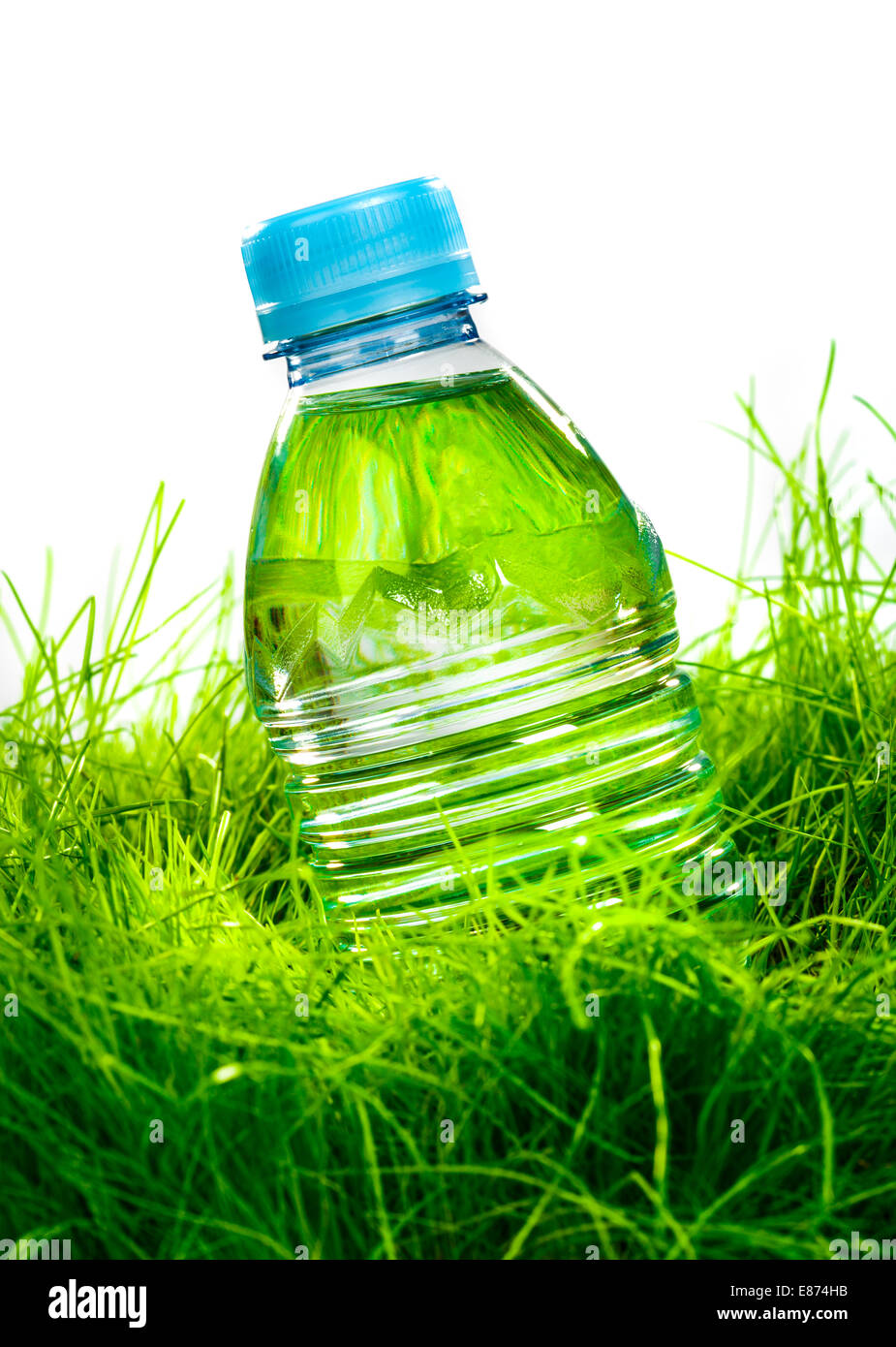 Bottle of water on the green grass isolated on white background Stock ...