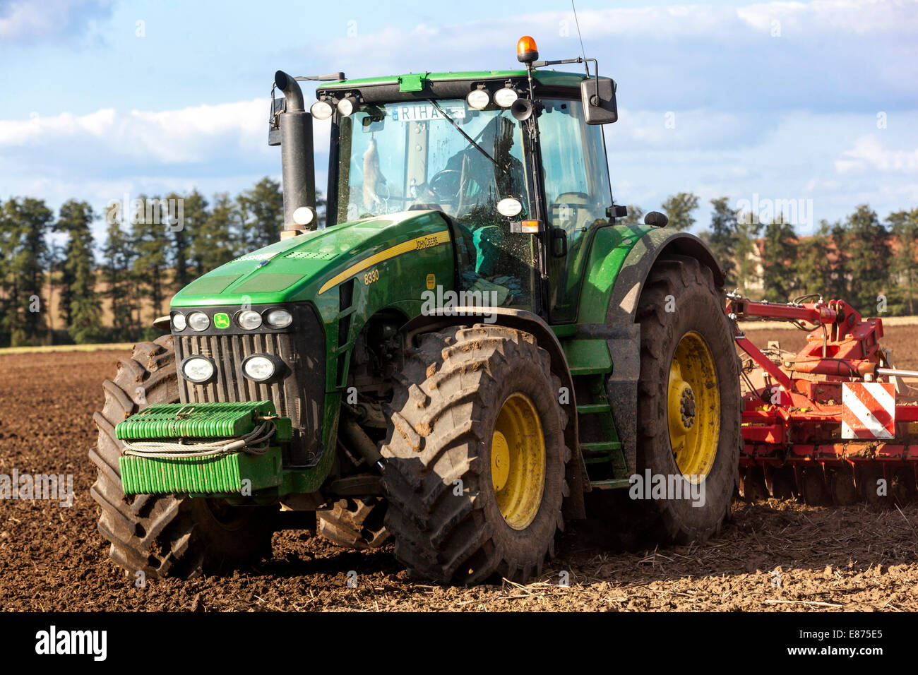 John Deere tractor ploughing field, Czech Republic farmer Stock Photo