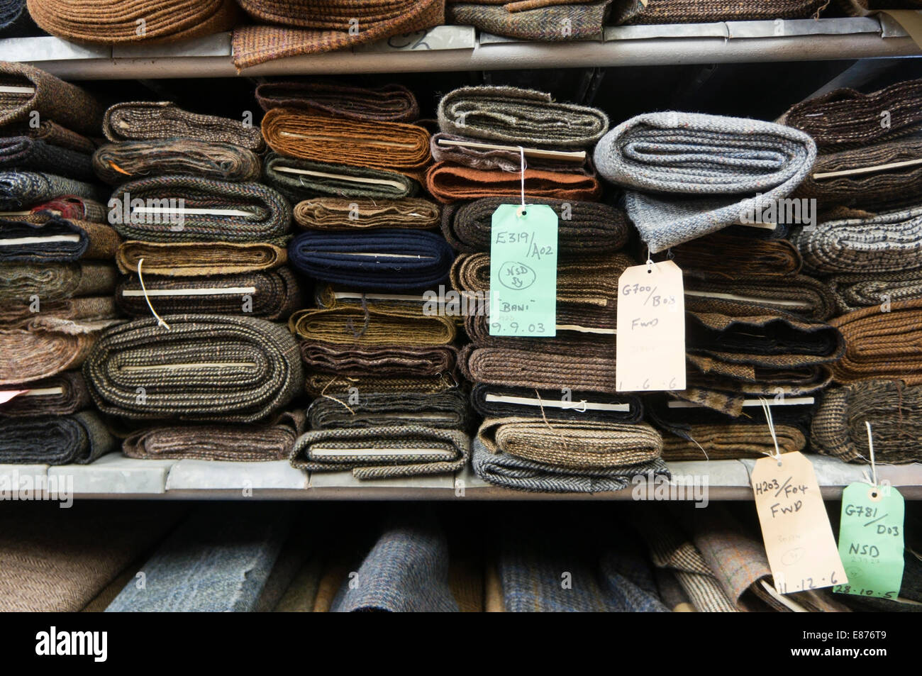 Rolls of Harris Tweed on warehouse shelves. Stock Photo