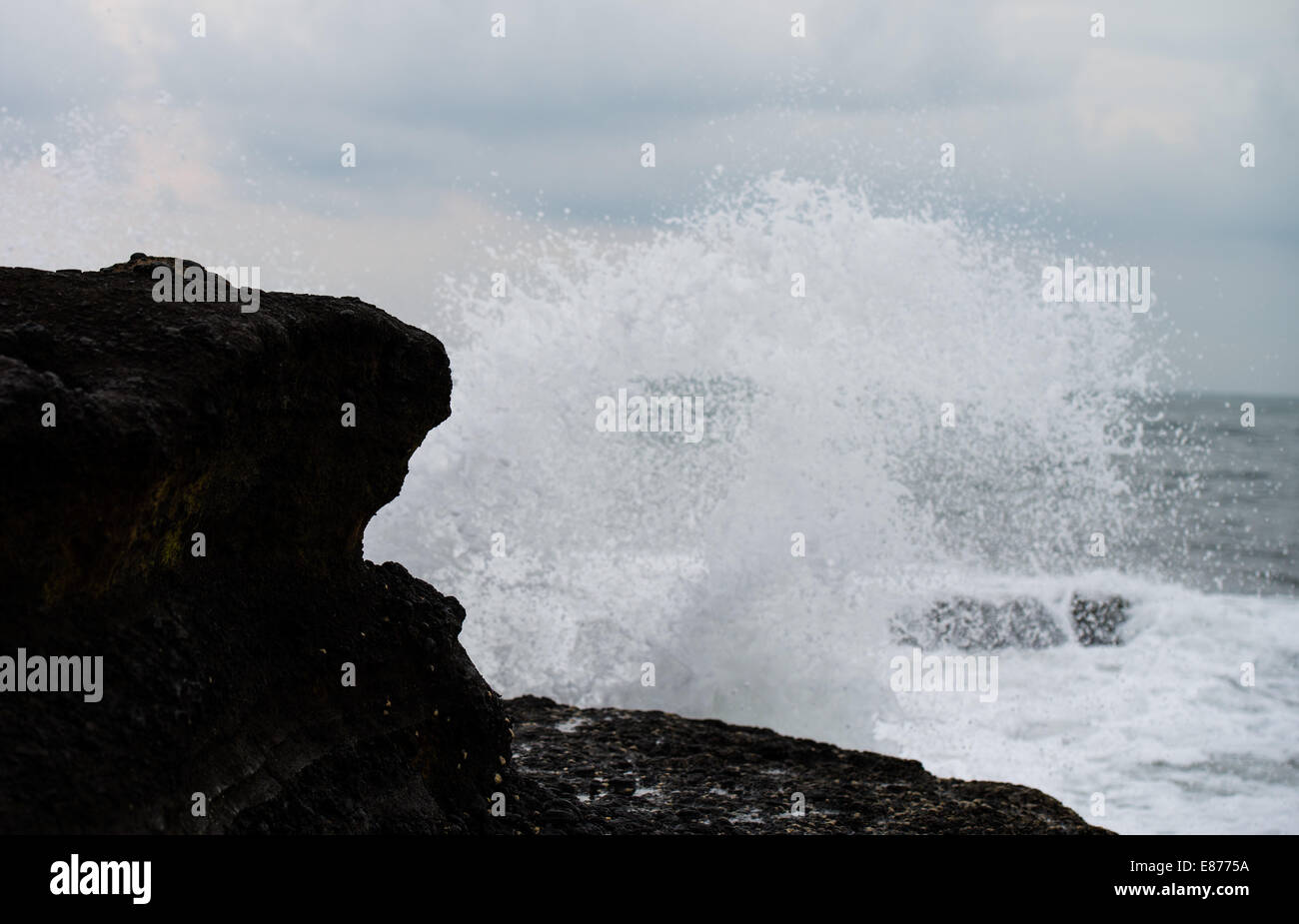splash of waves against the rock Stock Photo - Alamy