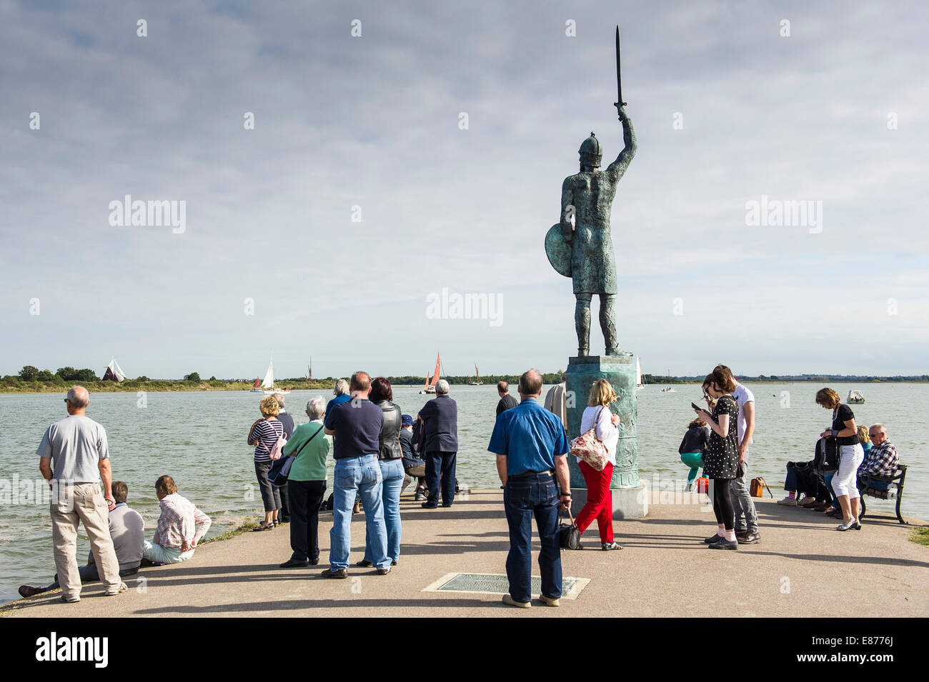 People gathering underneath the statue of Bryhtnoth on the promenade at Maldon on the Blackwater River in Essex. Stock Photo