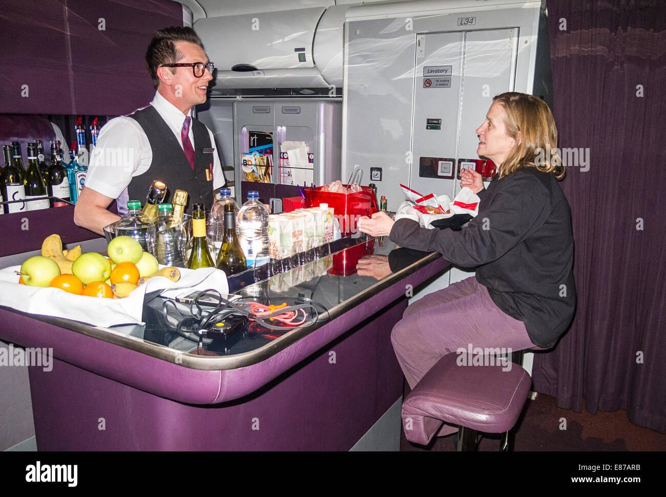 Flight attendant Lee Mallinson mans the upper class bar on a Virgin