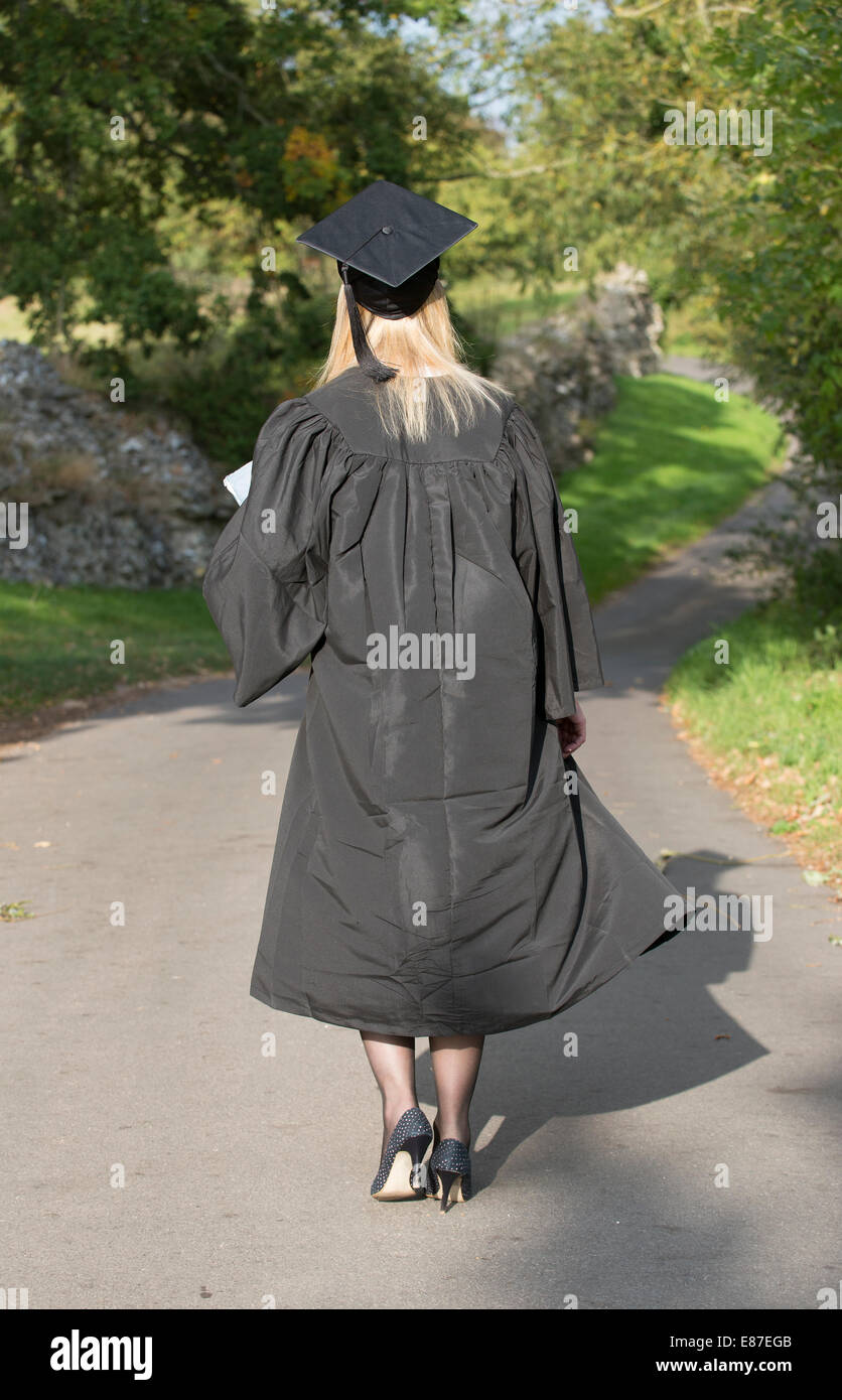 Mature female University student in cap and gown Stock Photo