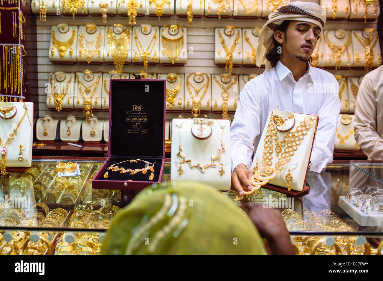 Gold sellers showing nechlaces in Gold Souk shops in Deira, Dubai, UAE