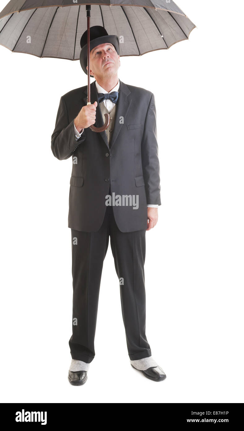 Middle aged  businessman in a retro business suit with umbrella isolated on white. Stock Photo