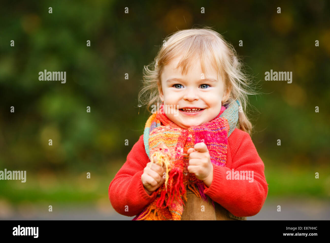 Happy little girl in the park Stock Photo - Alamy