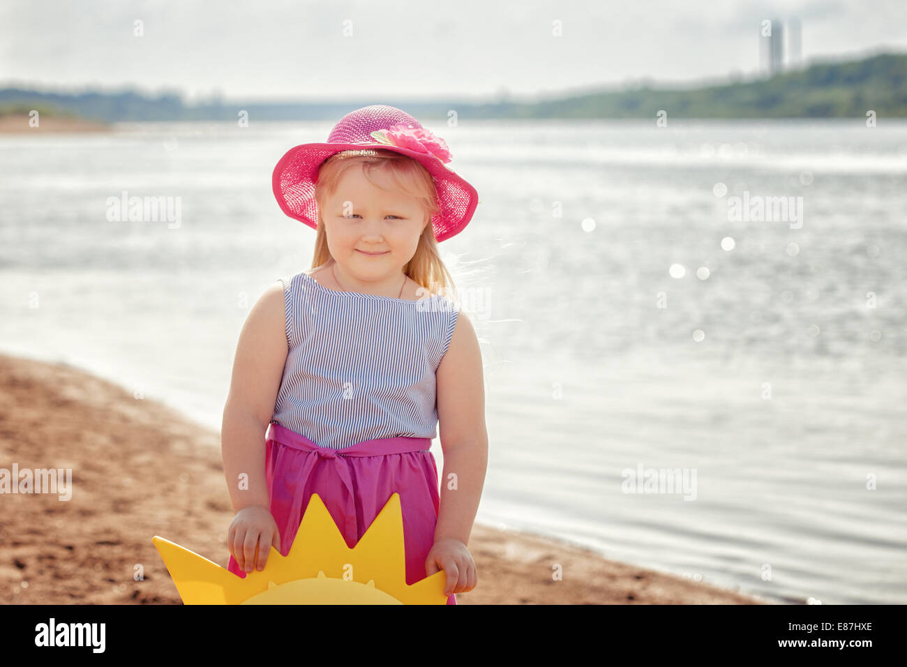 Smiling blond girl posing on river bank, close-up Stock Photo - Alamy