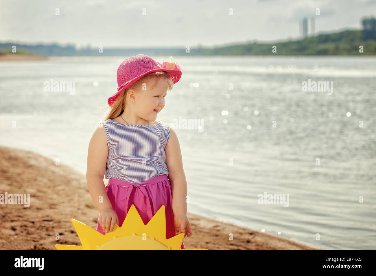 Merry little girl posing on river bank, close-up Stock Photo - Alamy