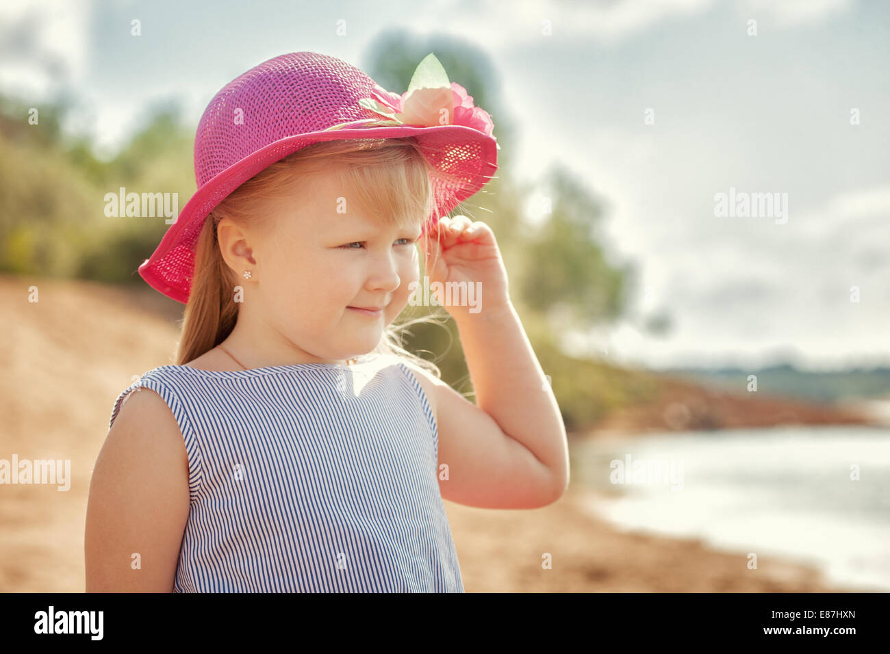 Image of smiling girl posing looking at river Stock Photo - Alamy