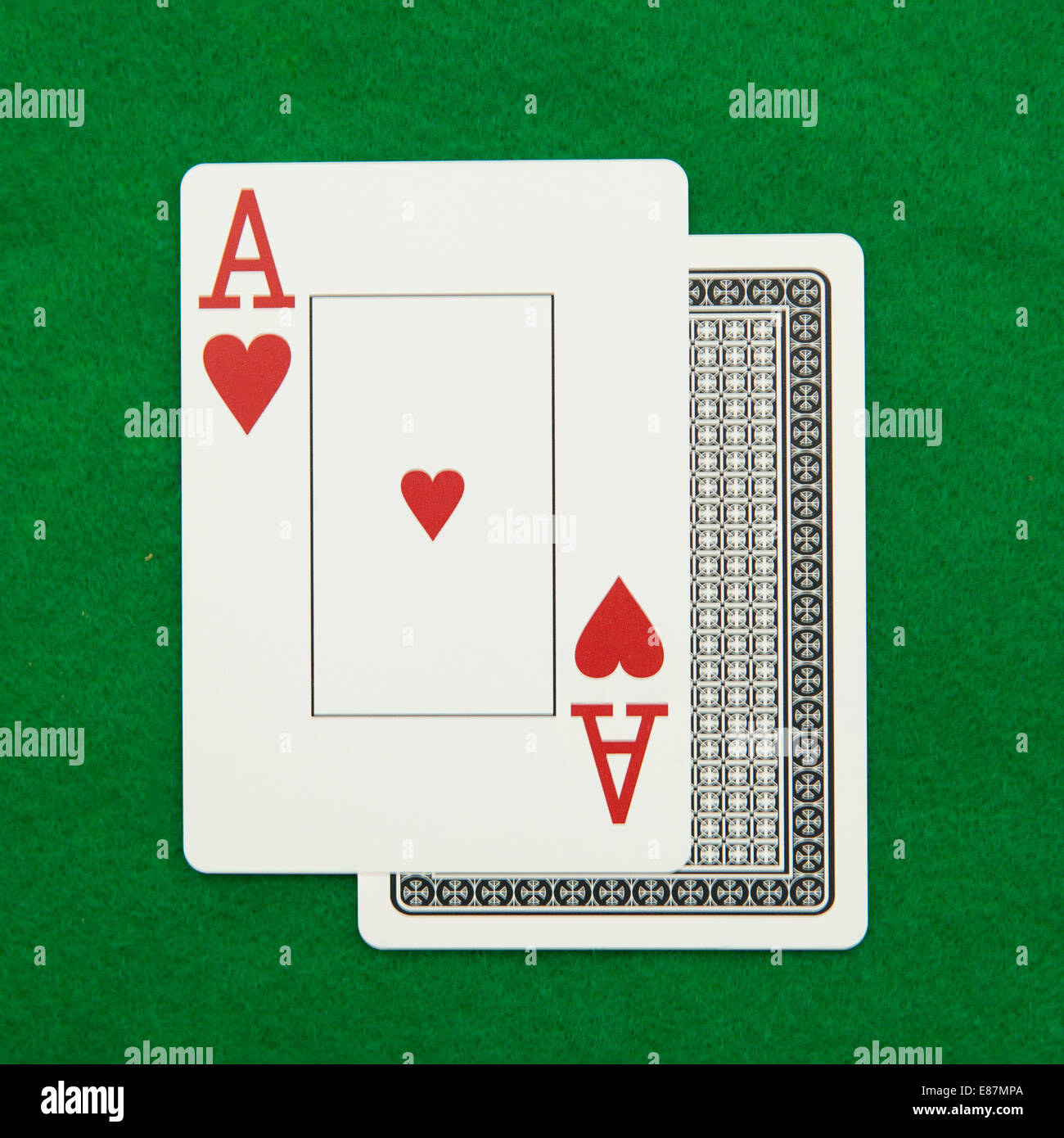 Blackjack hand with casino chip on green casino table Stock Photo