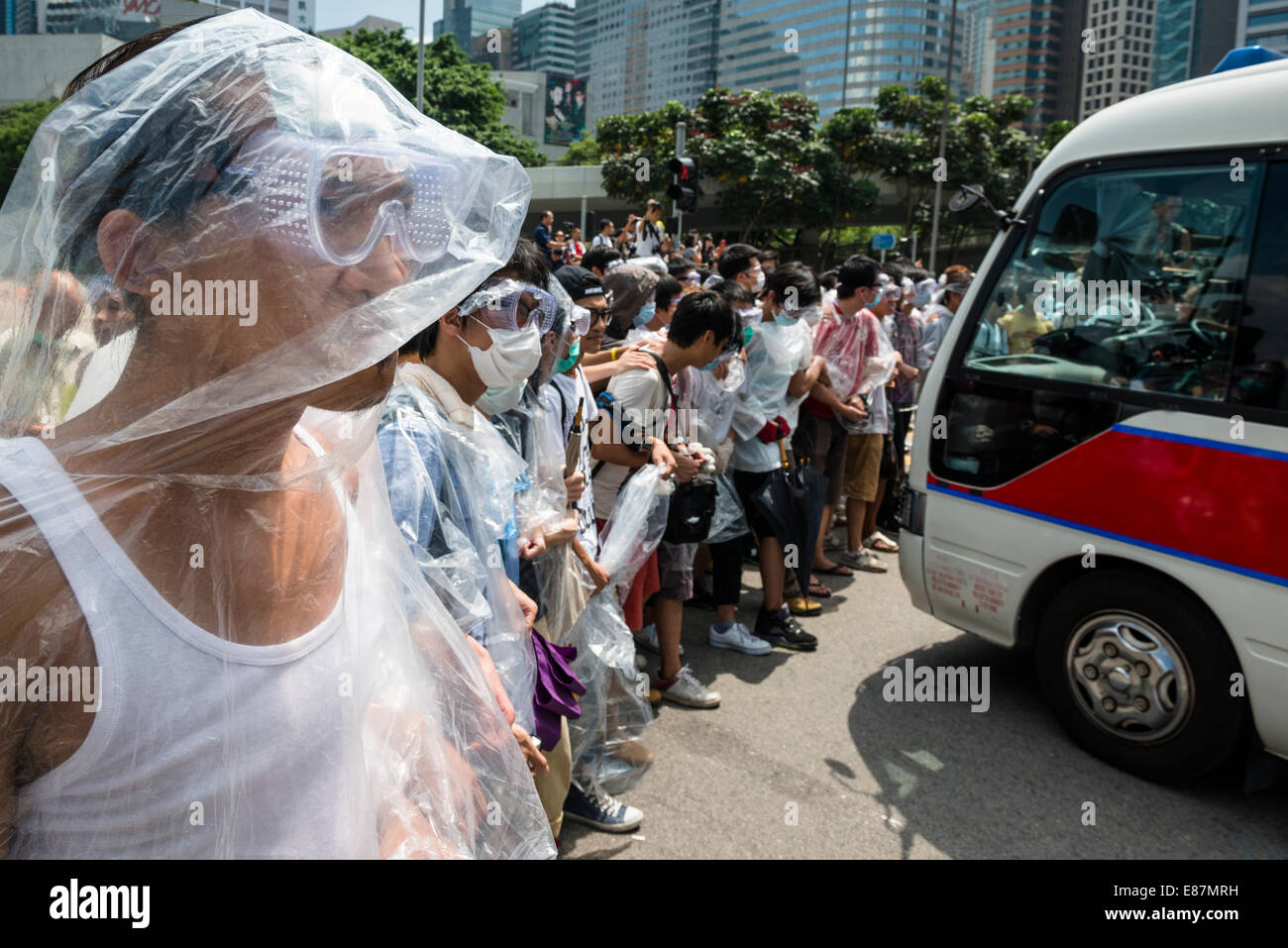 Protesters of Occupy Central are prepared for pepper spray and teargas with plastic raincoats and goggles. Stock Photo