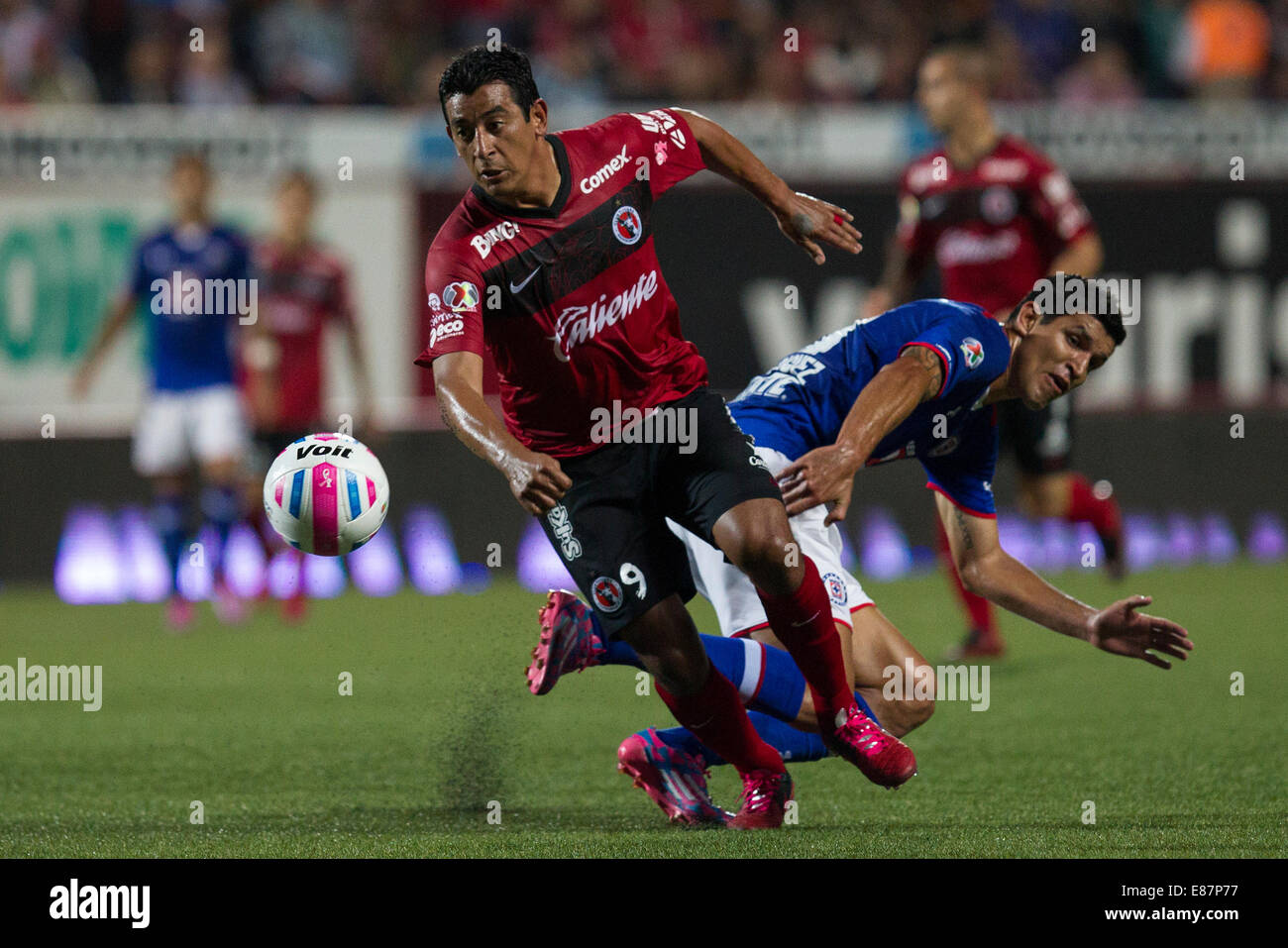 Tijuana, Mexico. 1st Oct, 2014. Alfredo Moreno (L) of Xolos vies for the ball with Francisco Rodriguez of Cruz Azul during their match of the 2014 MX League Opening Tournament held at Caliente Stadium in Tijuana city, northwest Mexico, on Oct. 1, 2014. Credit:  Guillermo Arias/Xinhua/Alamy Live News Stock Photo