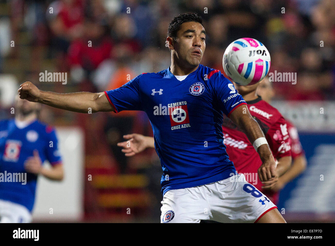 Tijuana, Mexico. 1st Oct, 2014. Juan Carlos Nunez (Back) of Xolos vies for the ball with Marco Fabian of Cruz Azul, during their match of the 2014 MX League Opening Tournament held at Caliente Stadium in Tijuana city, northwest Mexico, on Oct. 1, 2014. Credit:  Guillermo Arias/Xinhua/Alamy Live News Stock Photo