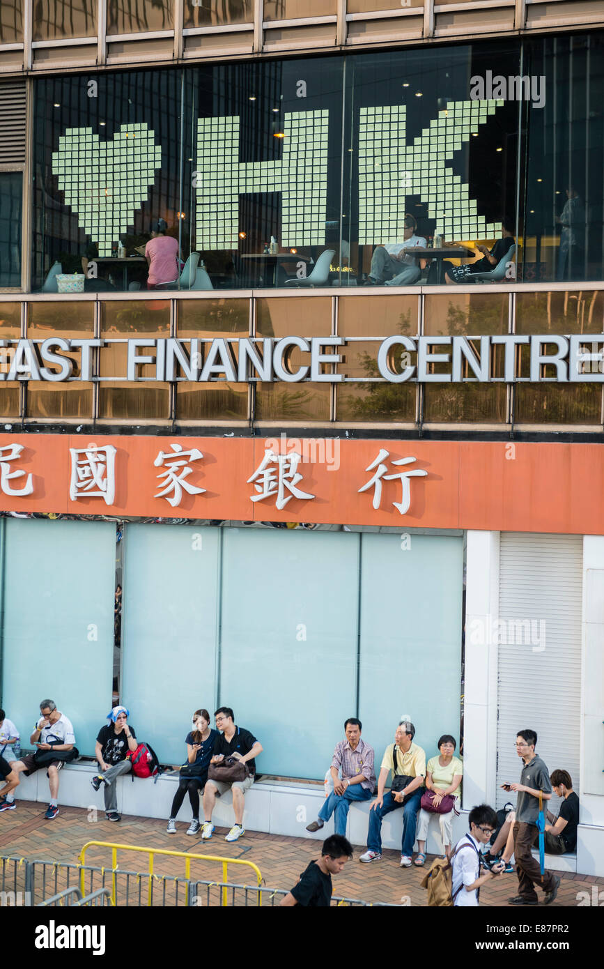 Hong Kong, China. 1st October, 2014.   Students and other supporters of the Occupy Central movement congregating around the government offices area at Tamar. All the roads in the area are blocked from traffic and public transport. Some businesses support the movement like this finance centre. Credit:  Kees Metselaar/Alamy Live News Stock Photo