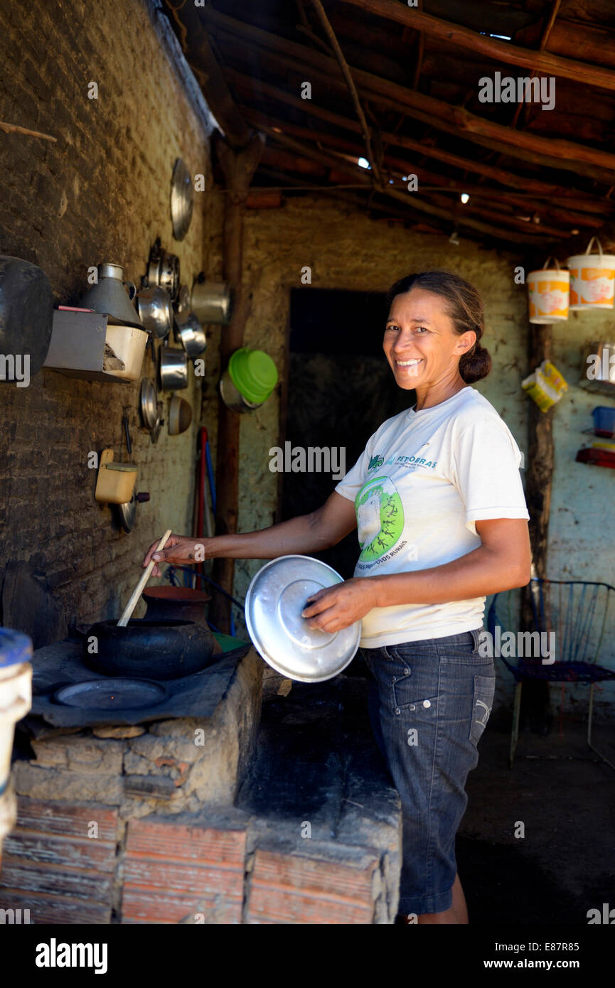 Woman at a simple cooking pit made of mud and bricks, Crato, State of Ceará, Brazil Stock Photo