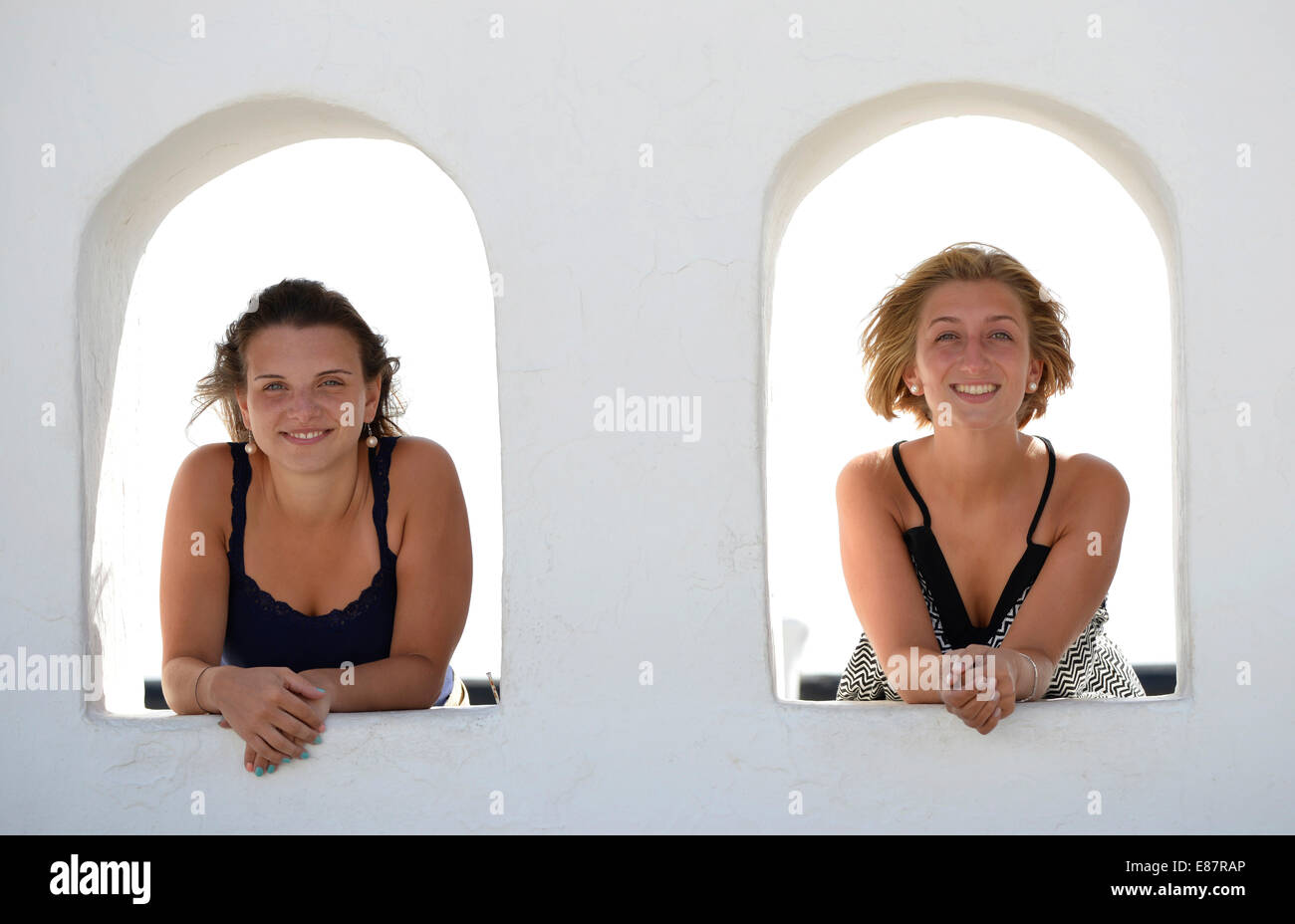 Two young women looking out from the Balcon de Femes, Femes, Lanzarote, Canary Islands, Spain Stock Photo