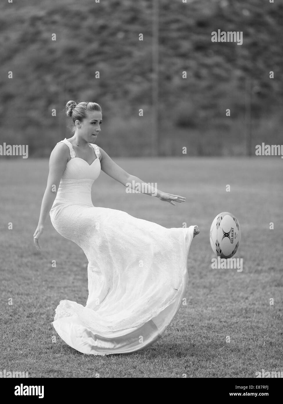 Trash the dress, Rugby, bride playing the ball Stock Photo