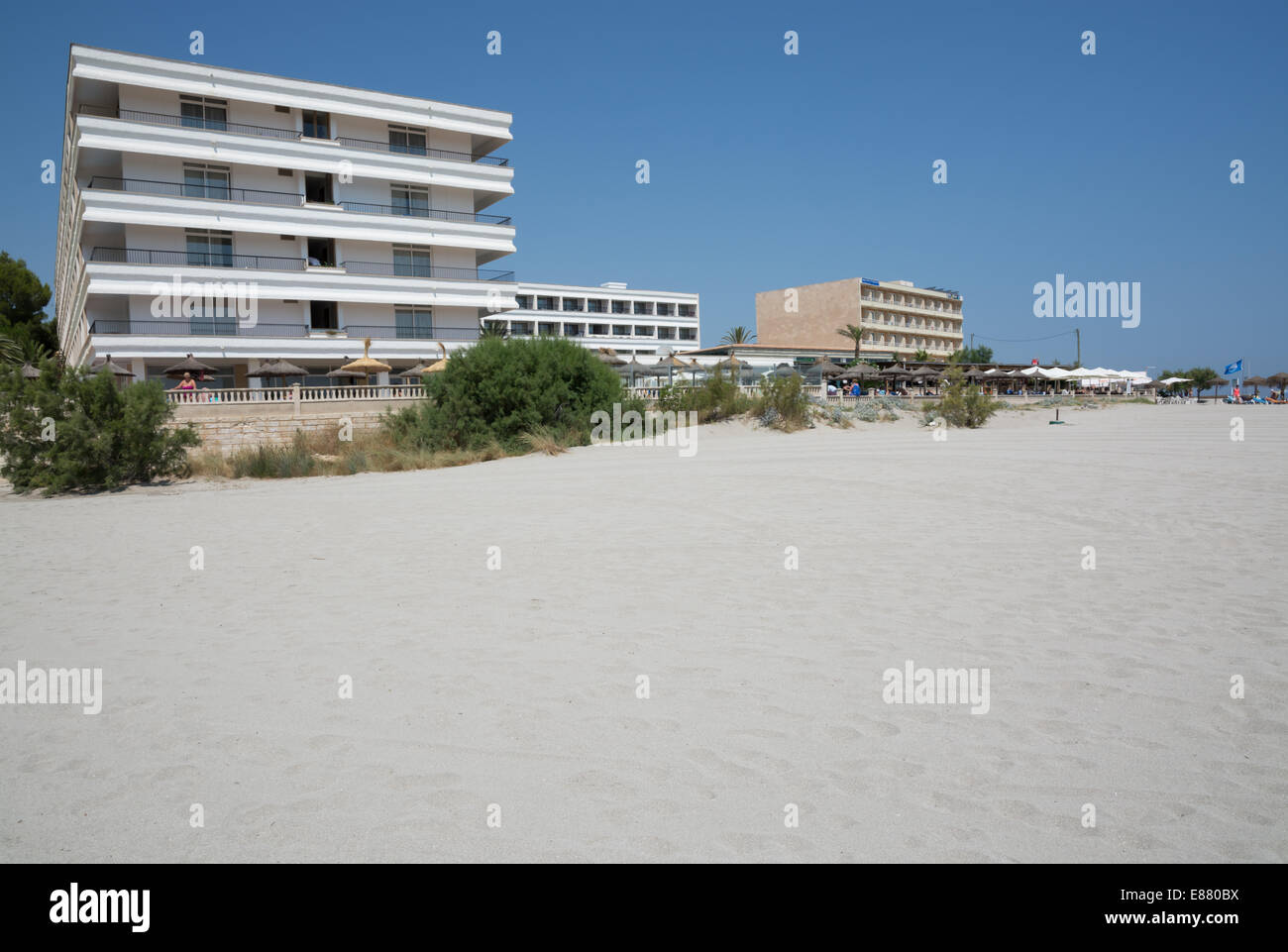 Sandy beach and hotels Hotel Son Baulo and Hotel Ferrer Concord. Can Picafort, Mallorca, Balearic islands, Spain on July 12, 201 Stock Photo