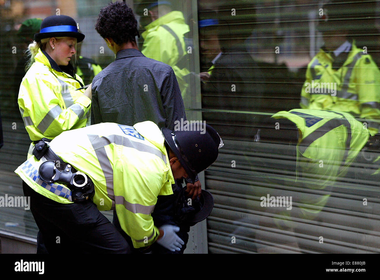 Police carry out drugs searches around the streets of Manchester.  Police search a suspected drug dealer in the northern quarter Stock Photo