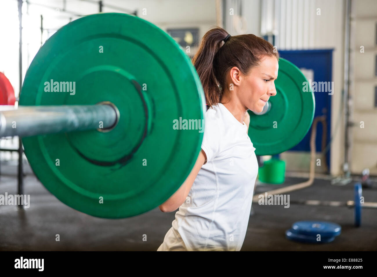 Fit Woman Lifting Barbell in Gym Stock Photo - Alamy