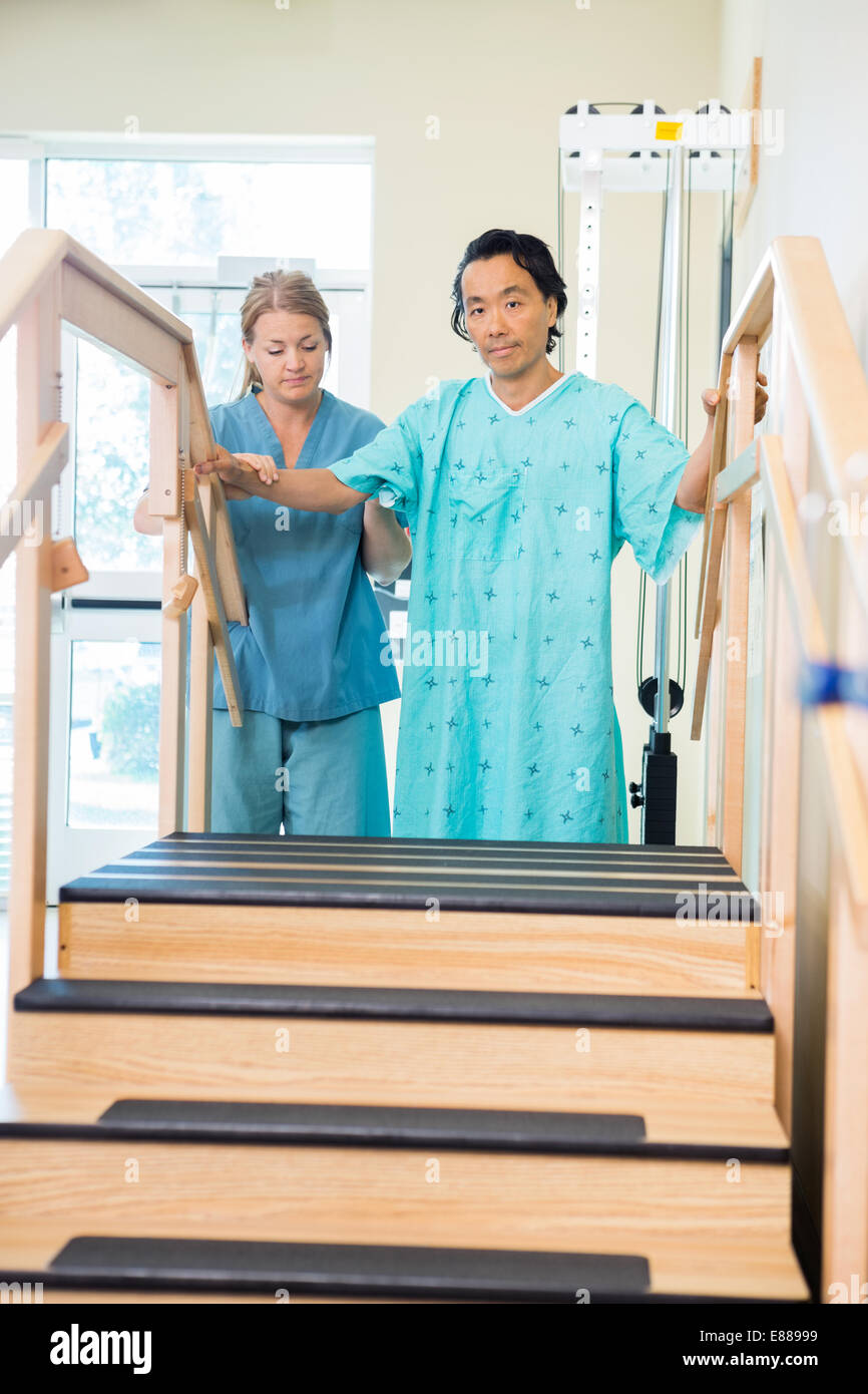 Male Patient Being Assisted By Nurse Stock Photo