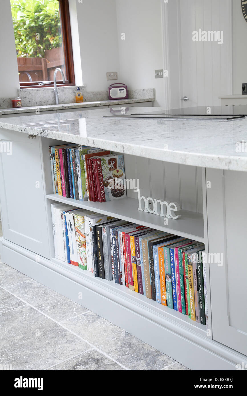 Bookshelf Built Into A Kitchen Island With A Marble Work Top Stock