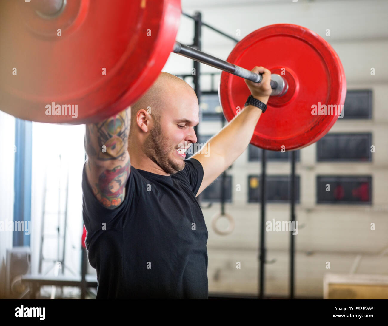 Athlete Exercising With Barbell At Gym Stock Photo