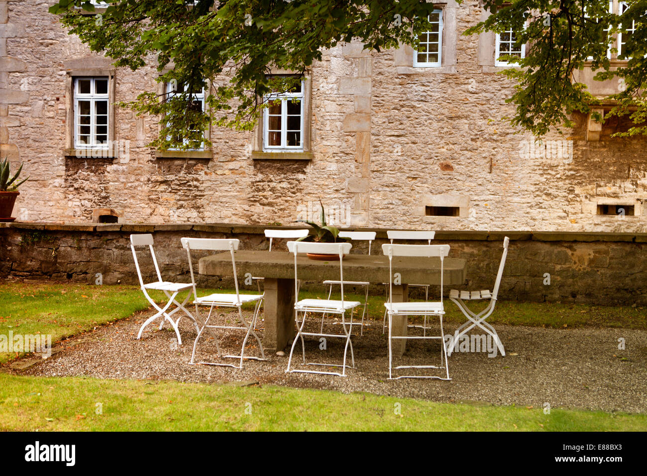 Chairs and tables outside, Schloss Huelsede, moated Castle in Huelsede, Weser-Renaissance, Lower Saxony, Germany, Europe, Stock Photo