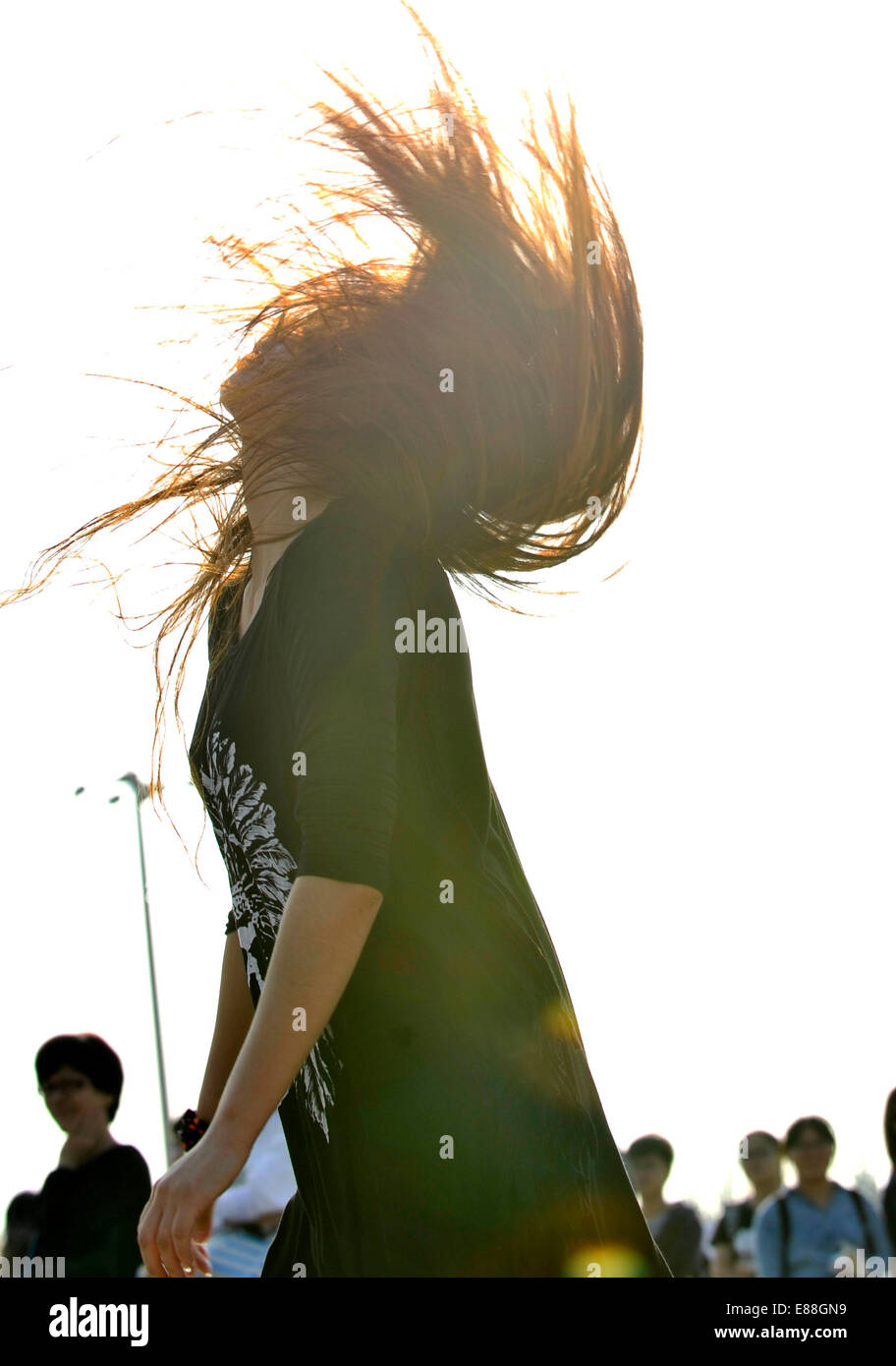 Tianjin, China. 2nd Oct, 2014. A music fan throws her hair with music at the Strawberry Music Festival in Tianjin, north China, Oct. 2, 2014. Credit:  Yue Yuewei/Xinhua/Alamy Live News Stock Photo