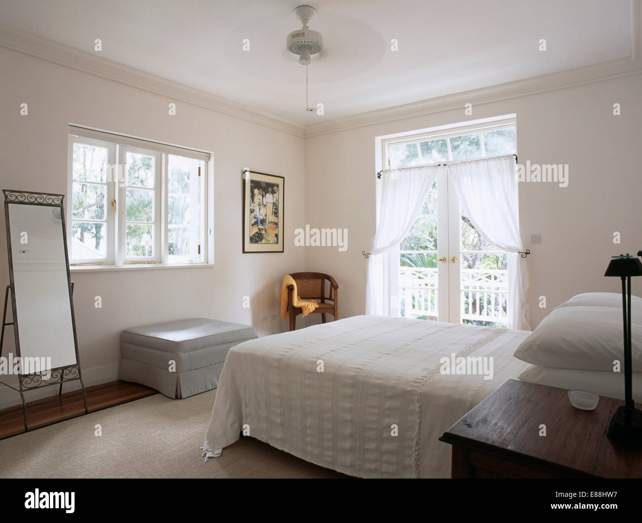 Modern White Bedroom In Barbados With Ceiling Fan Above Bed With