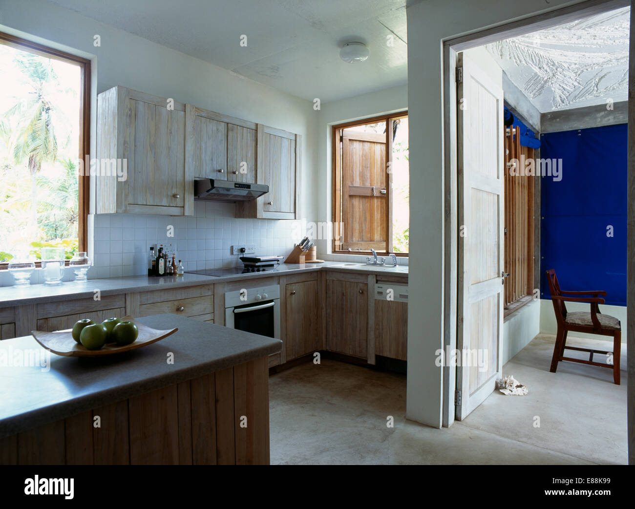 Polished concrete floor in modern kitchen with Corian worktops Stock