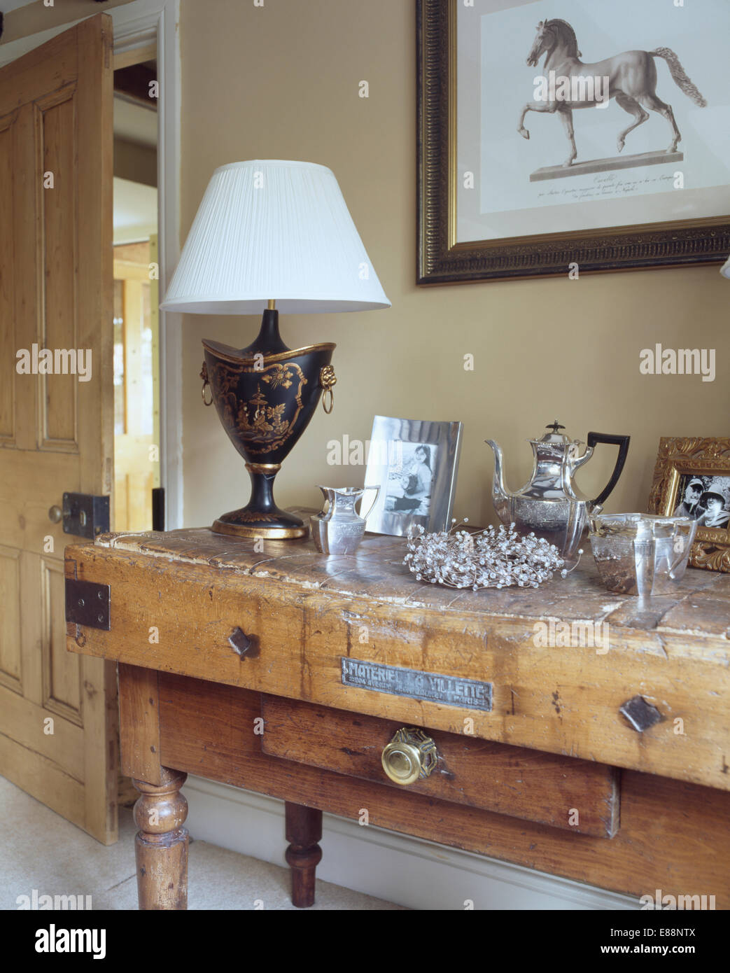 Shading Silverware Silverware and lamp with white shade on antique butcher's block in ...