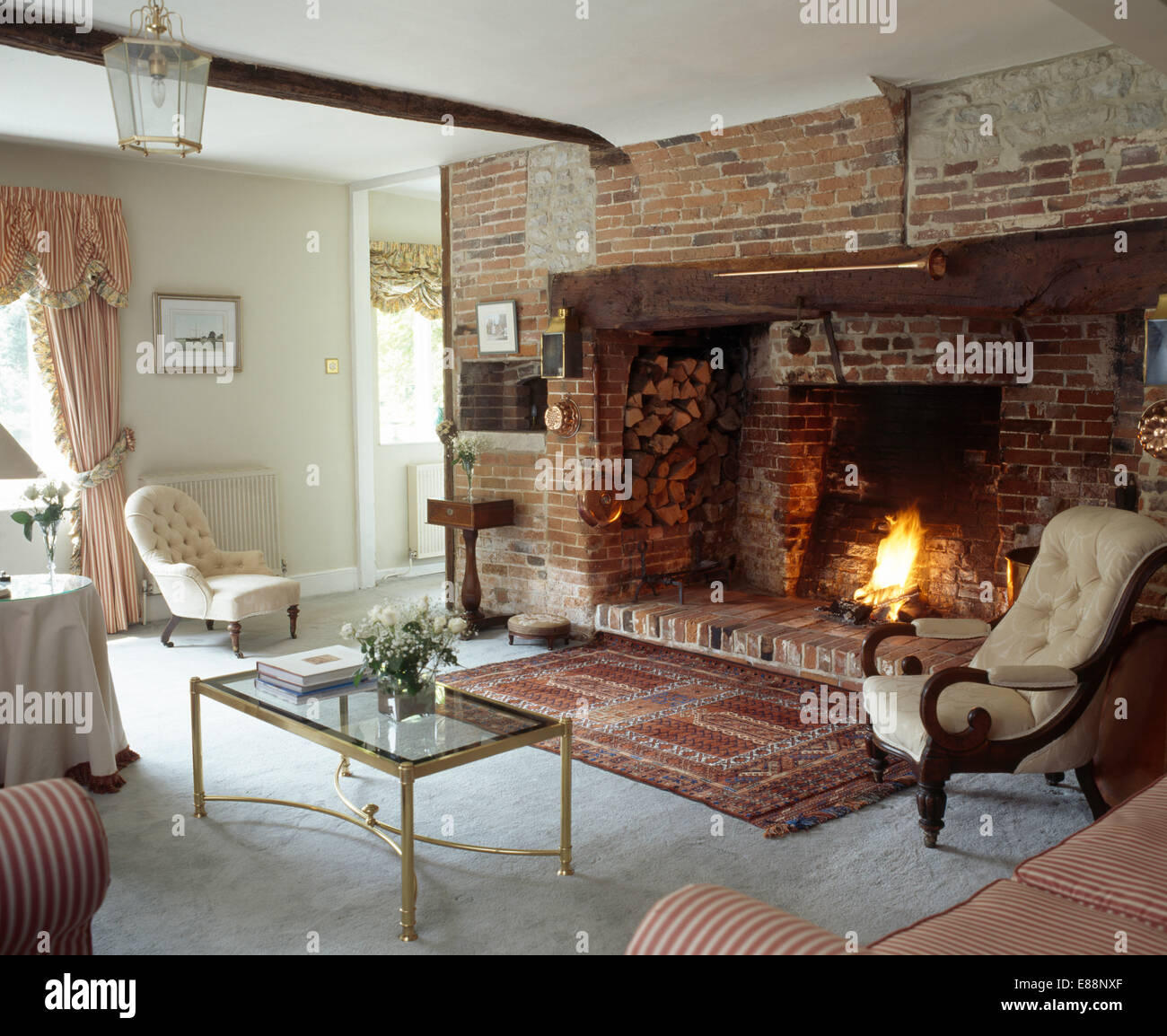 Oriental rug in front of inglenook  fireplace  in cottage 