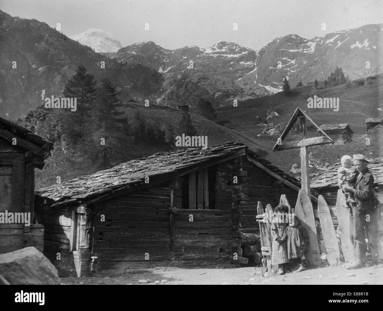 Children in the mountain hamlet of Blatten and the  Breithorn, Switzerland. 1907. Reproduced from a glass lantern slide. Stock Photo