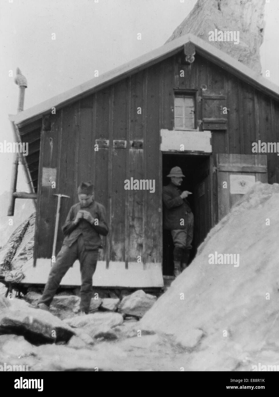 Climbers outside the Cabane de Bertol, Arolla, Switzerland. July 1911.  Reproduced from a glass lantern slide. Stock Photo