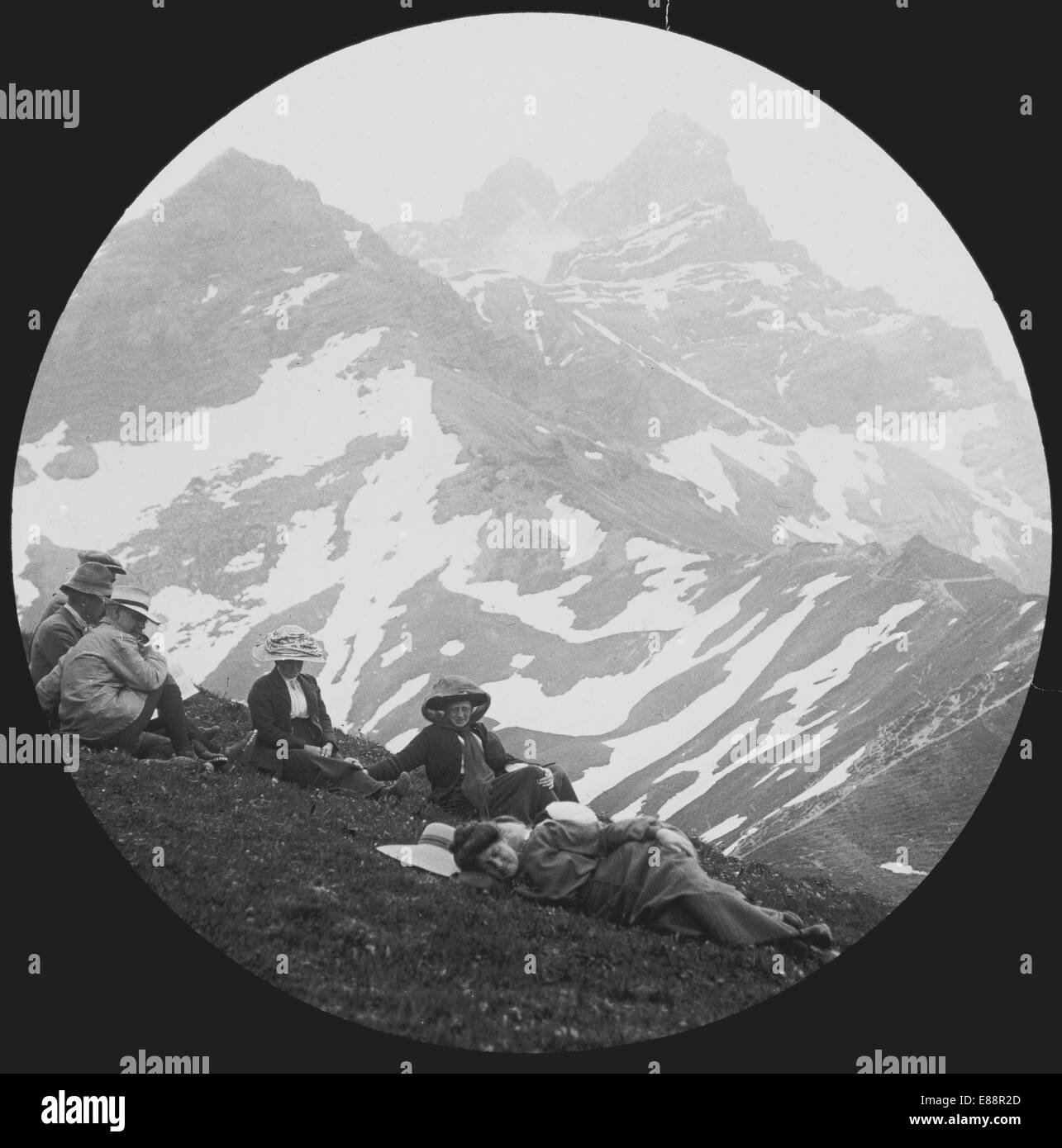 Walkers in period dress resting at the Croix de Javerne.  near Bex, Vaud, Switzerland. 1912. Stock Photo