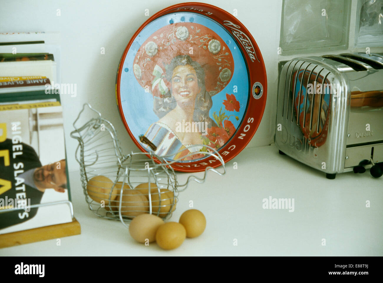 https://c8.alamy.com/comp/E88T9J/close-up-of-retro-pictorial-forties-tray-on-worktop-with-wire-basket-E88T9J.jpg