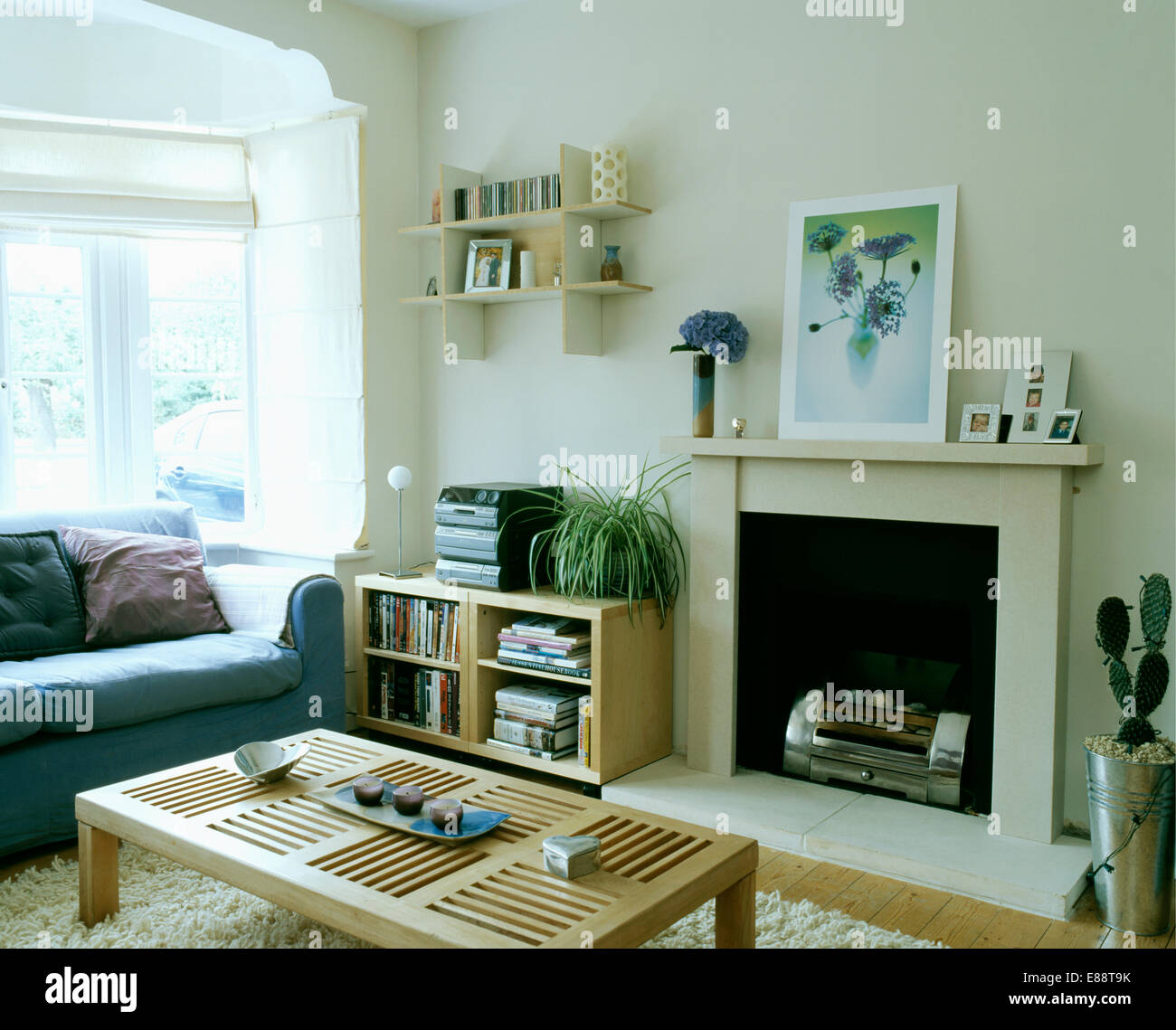 Small Wall Shelves Above Low Pale Wood Shelf Unit With Music Centre Stock Photo Alamy