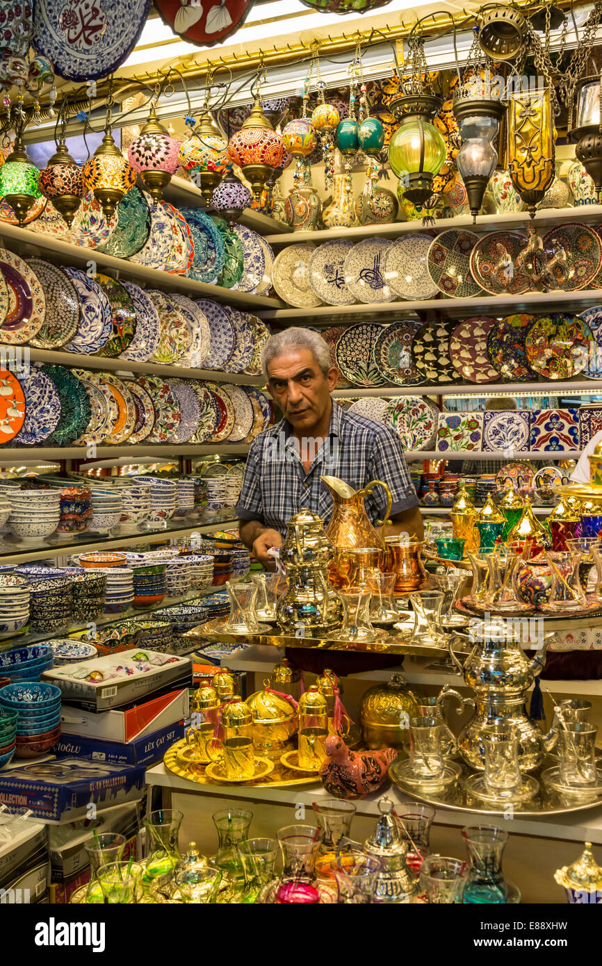 Seller (vendor) of traditional Turkish ceramics, glassware and tea sets in his shop, Grand Bazaar, Istanbul, Turkey, Europe Stock Photo