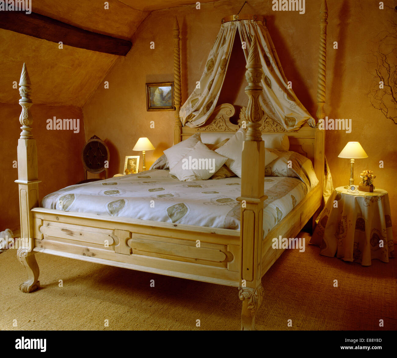 with silk drapes above painted bed with spindle posts and patterned bedlinen in country