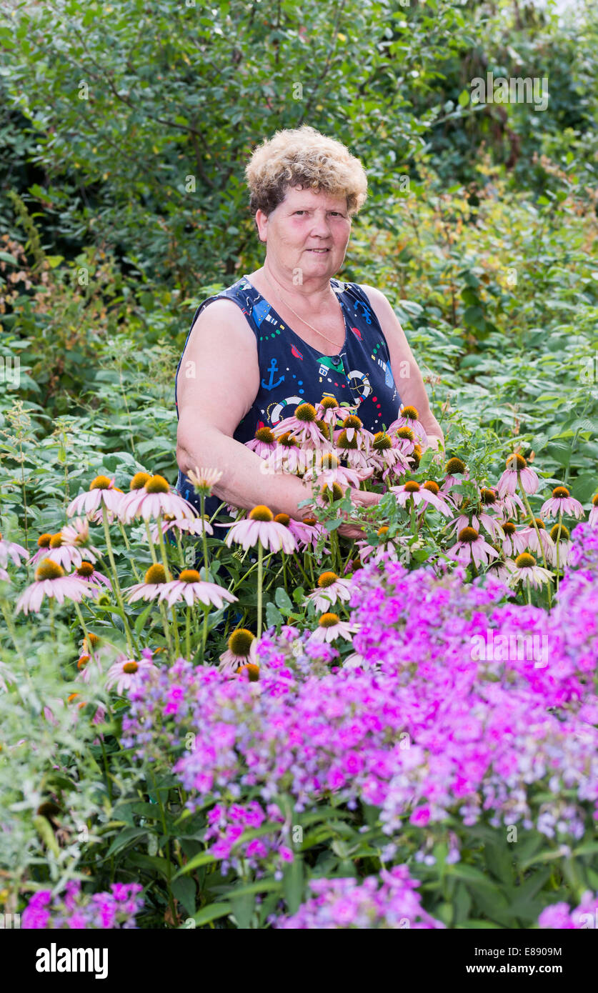 mature woman with flowers at garden Stock Photo - Alamy