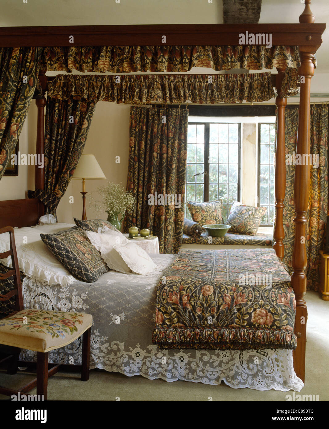 William Morris drapes on four poster bed with lace bed cover and folded