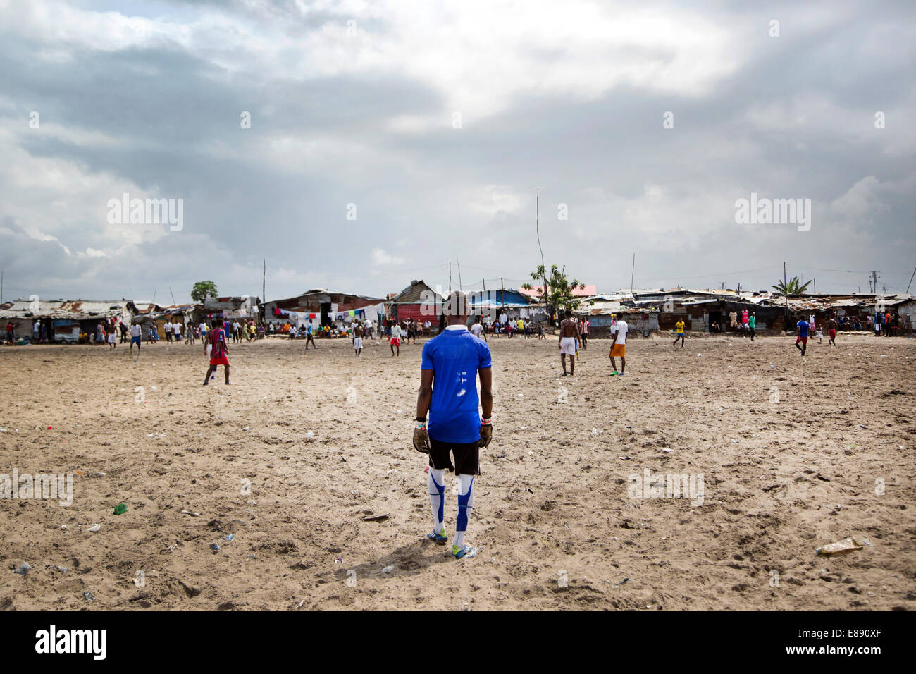 Men in the township of West Point passed the time by playing soccer during the quarantine. Monrovia, Liberia 2014-08-29 06:20:38 Stock Photo