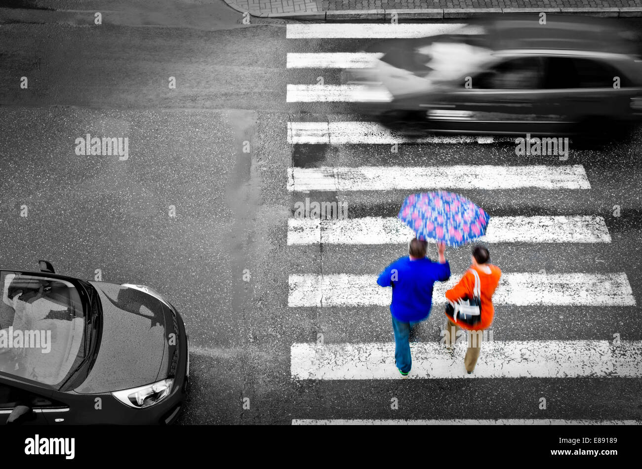 pedestrian crossing with cars in the rain Stock Photo - Alamy
