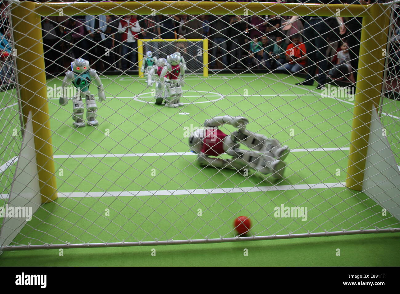 The Turkish robot-goalie (R) lies fallen after a German goal at 'Robogol 2014' in Istanbul, Turkey, 27 September, 2014. The team 'B-Human' from Bremen plays against 'Cerberus' from Bogazici University in Istanbul at Robogol. The game was organized for the German-Turkish Year of Science by the German embassy and the Koc-Museum, where the games are taking place. Photo: Can Merey/dpa Stock Photo